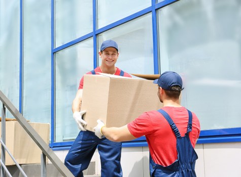 Moving team transporting furniture from an Islington apartment